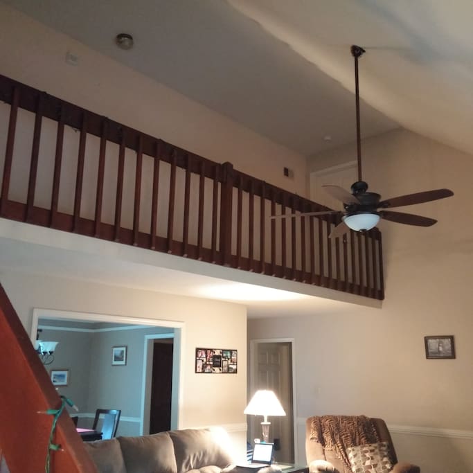 Second story loft with a high ceiling overlooking the living room