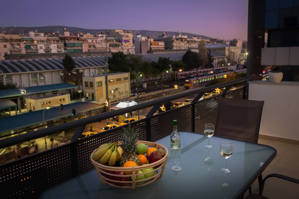 Spacious balcony overlooking evening Athens