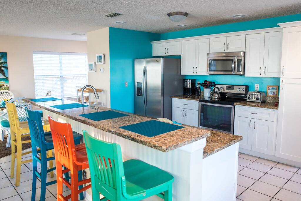 Kitchen opens to living room space.