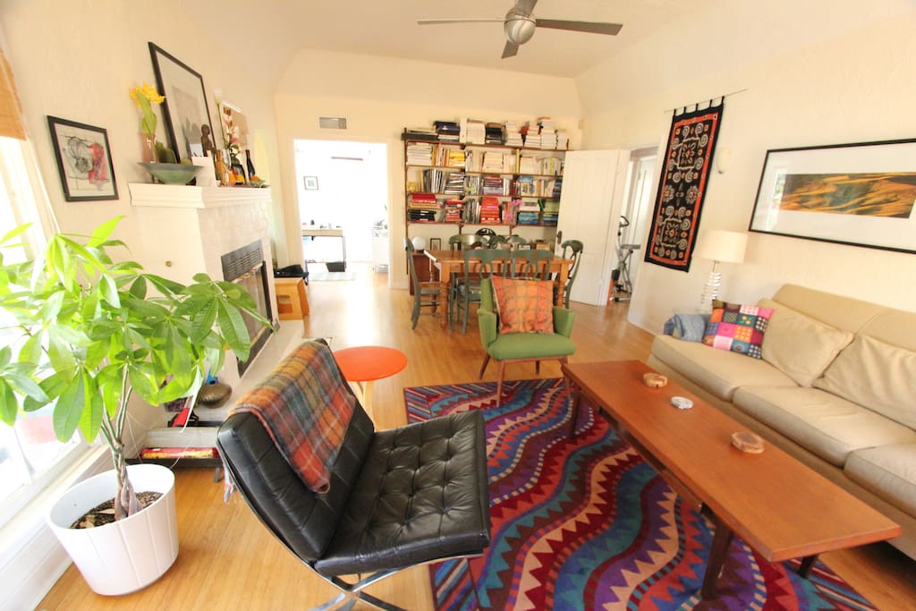 A Barcelona chair and designer midcentury furniture in the living room. A queen air mattress can be added to the living room if needed and doors can be closed for privacy from the bedrooms.