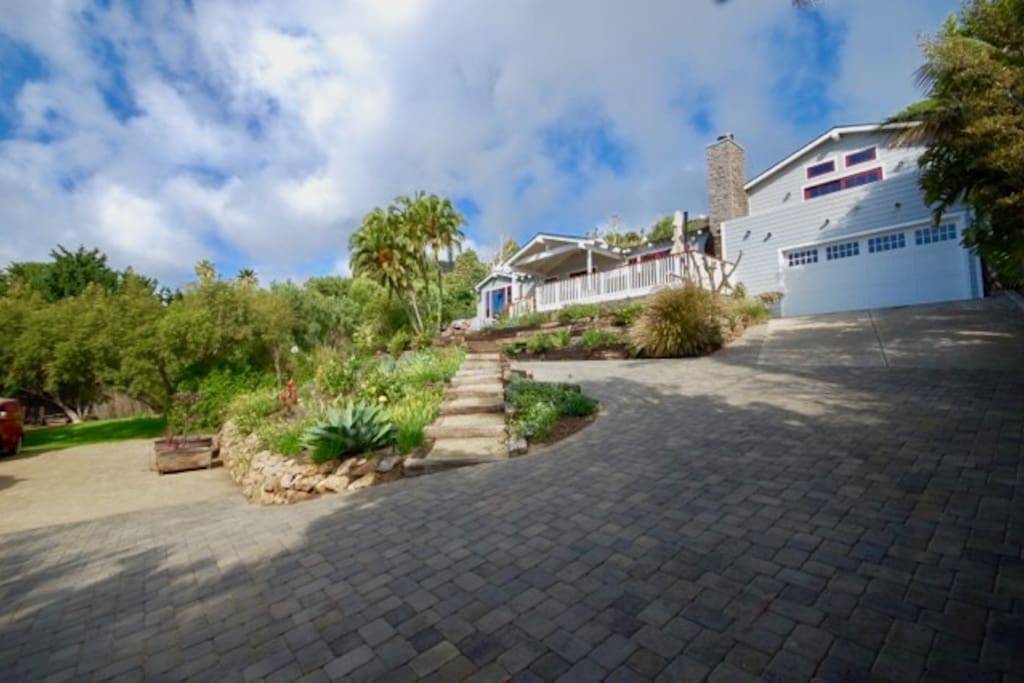 Driveway with generous parking area and large flat area to the left for extra parking.