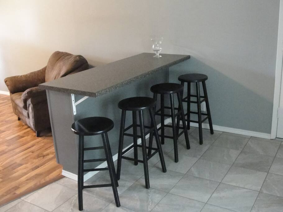 Counter overlooking family room, place to eat and view large screen tv.