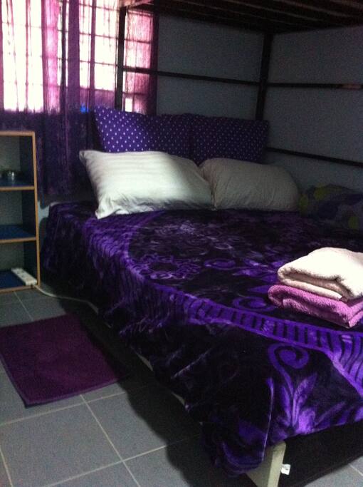Comfortable bed with linens and towels