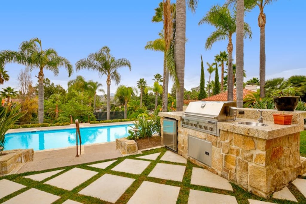 Built in barbecue with refrigerator for easy poolside entertaining.