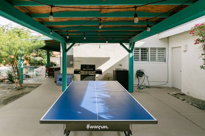 Covered ping pong table and BBQ grill. 
