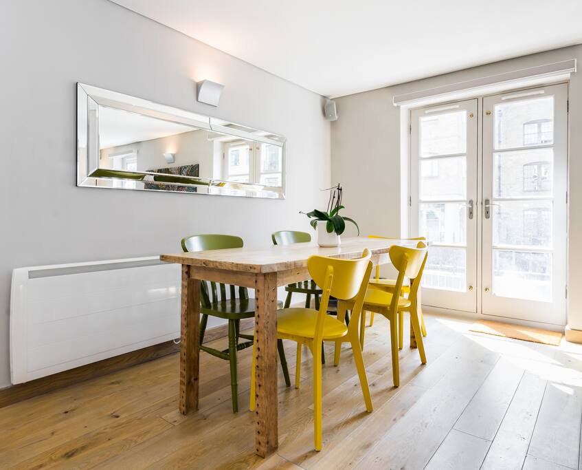 The stylish dining area with a beautiful wooden table.
