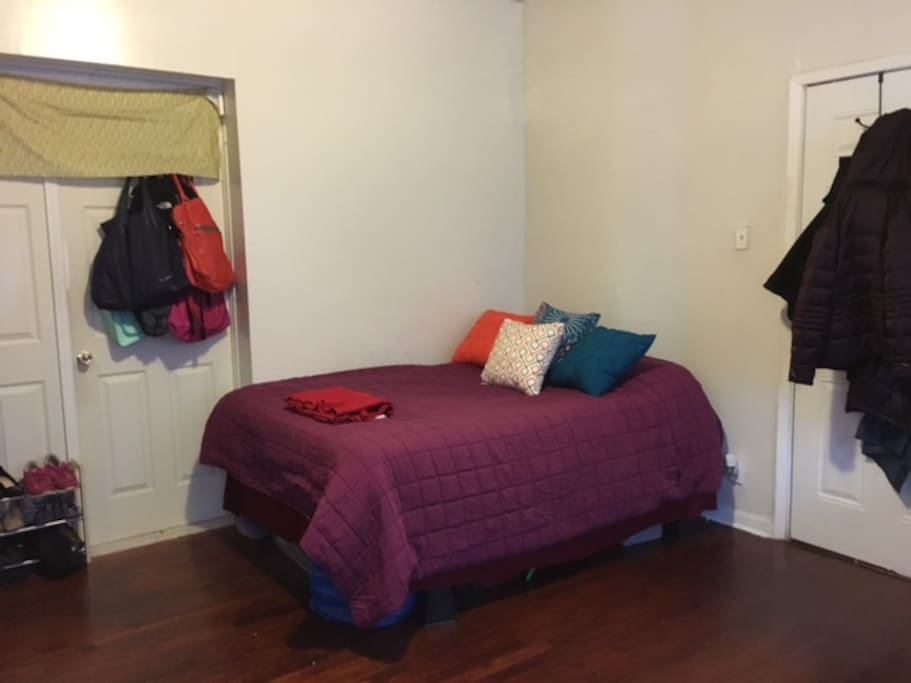 Queen sized bed. Private entrance into room on the right. Door to kitchen and bathroom on the left.