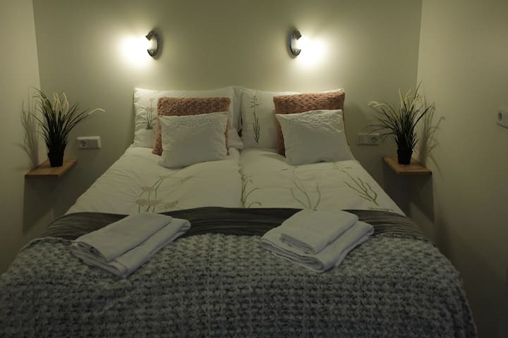 Made up double bed and towels.