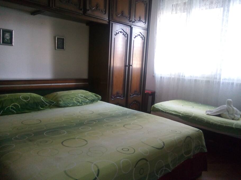 Bedroom with one big bed and one little.