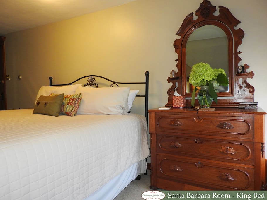 King bed and antique dresser with mirror.