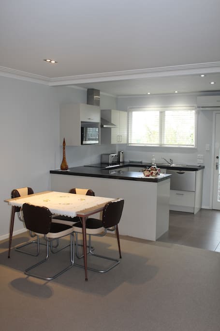Here is the dining table with the kitchen in the background.