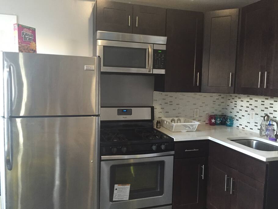 Kitchen fully equipped with cooking pans, cutlary, water kettle