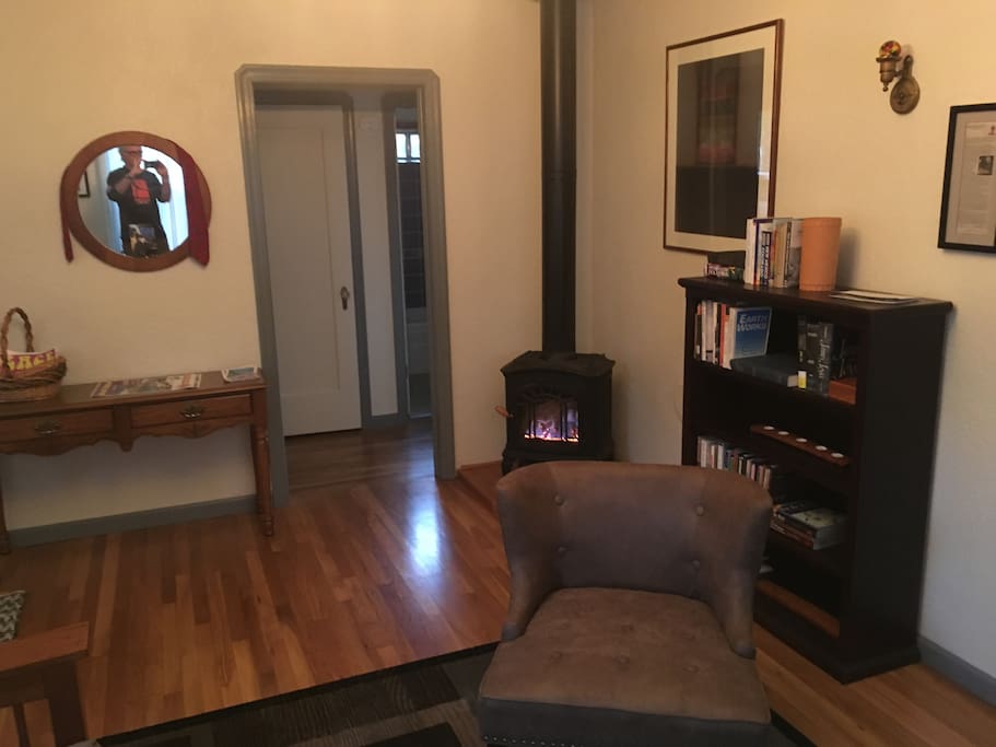 Toasty gas stove in living room--swamp cooler for hot days and nights. Plus: awesome nature-oriented library (well, bookshelf...)