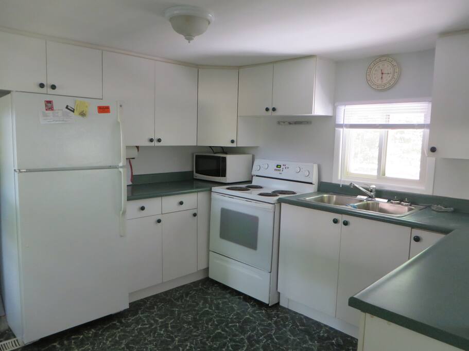 Full kitchen overlooking living area