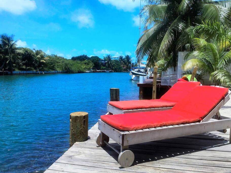 Lounge on the dock overlooking the canal, in a marina-like setting.
