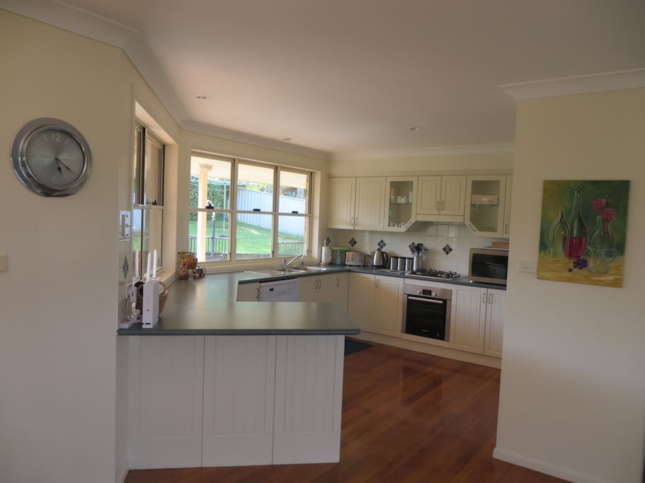Fully fitted kitchen with view from two large windows of the pool area