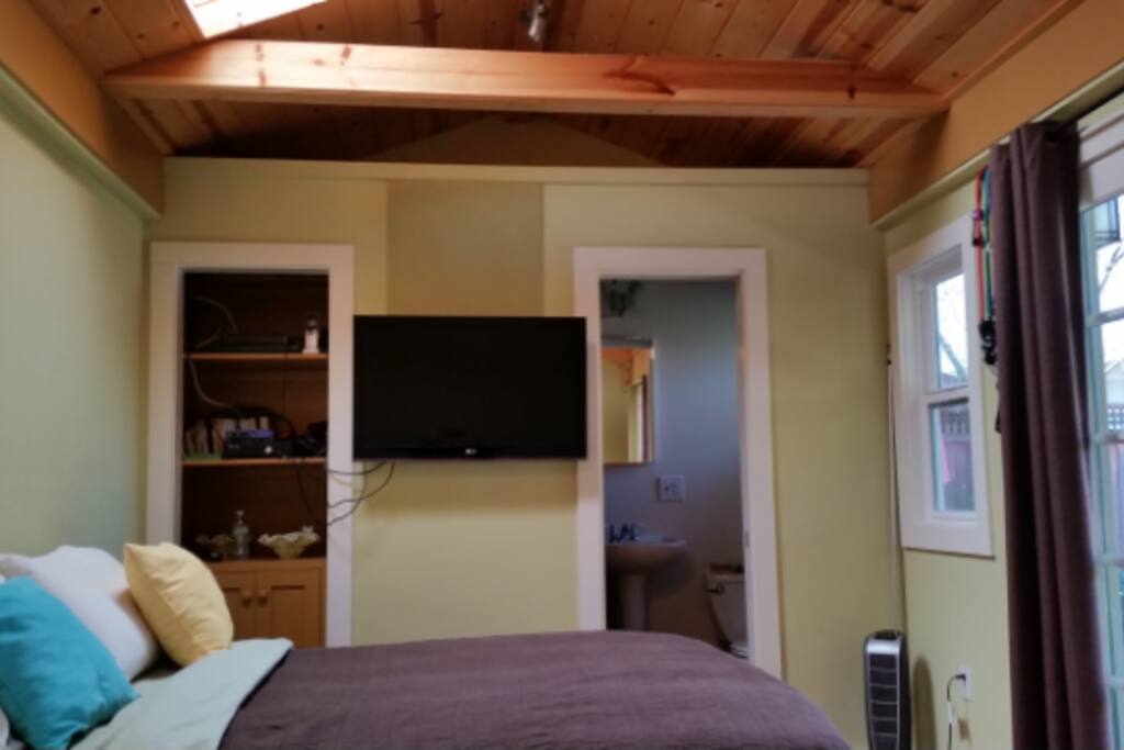 Full bath, sundry cabinet, and full size air mattress on an elevated frame.