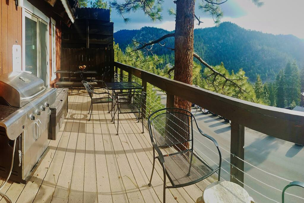 Spacious barbeque deck with benches, seating and extra tables.