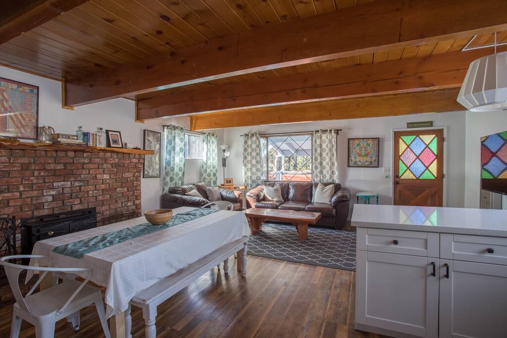 Living room with fireplace, breakfast bar, and extendable dining room table