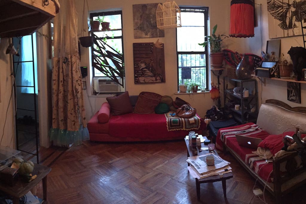 This is our shared living room. It's filled with art and hand-made decor. It is super cozy and good for working at home or hanging with roommates or friends.