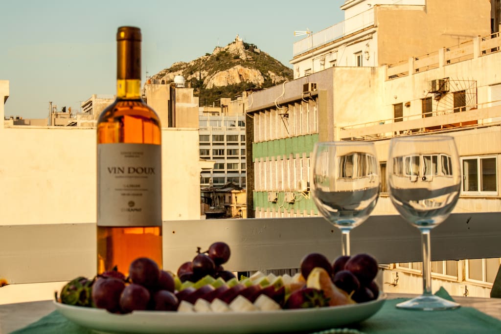 Enjoy a glass of wine gazing the city view