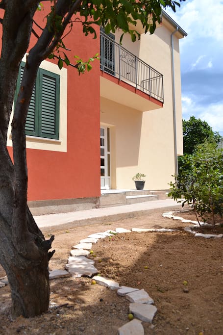 Entrance to the house and apartment's balcony above it