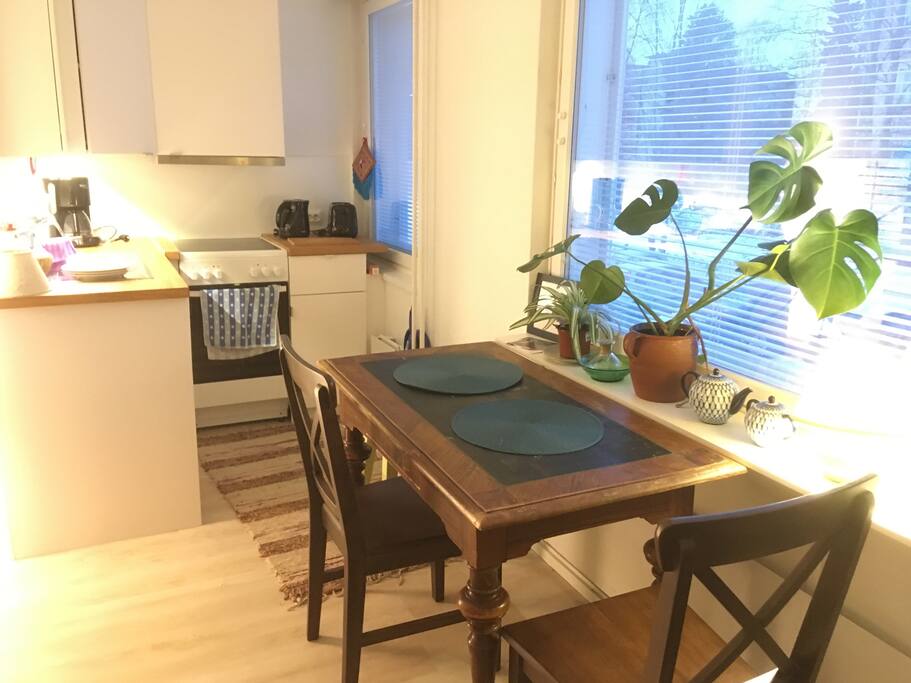 A dining table for three / a work desk overlooking the front yard.