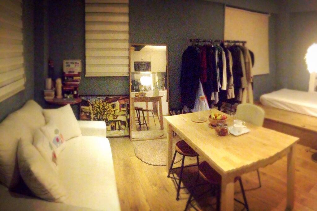This gives you an overview of my studio , cosy white linen sofa with sufficient pillows , luxurious timber wooden floor , long wooden table and industrial-fuelled chairs , coat hanging set , long wooden-framed mirror , clothing rack ( which I will clear space for you when I leave) , unique bed platform with single sized bed ( trust me , you can squeeze two people ) - I will provide full sets of new bedding for you , including covers , pillows , sheets, ready for a good sleep :) , and my beloved feather lamp , full kitchen equipment , kettle , juice maker , rice maker , fridge , microwave , aircon and heater