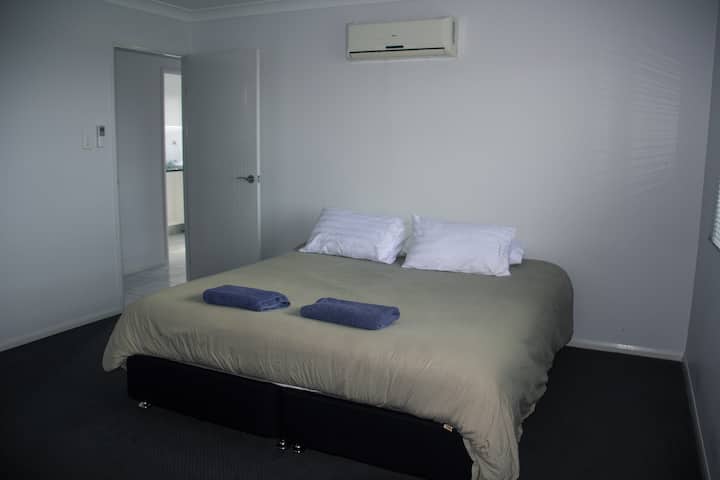 king bed with walk in robe and ensuite