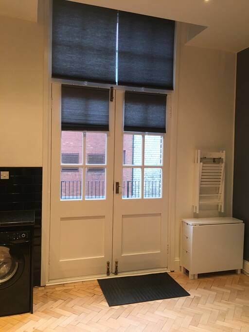 Double doors leading into large roof terrace.