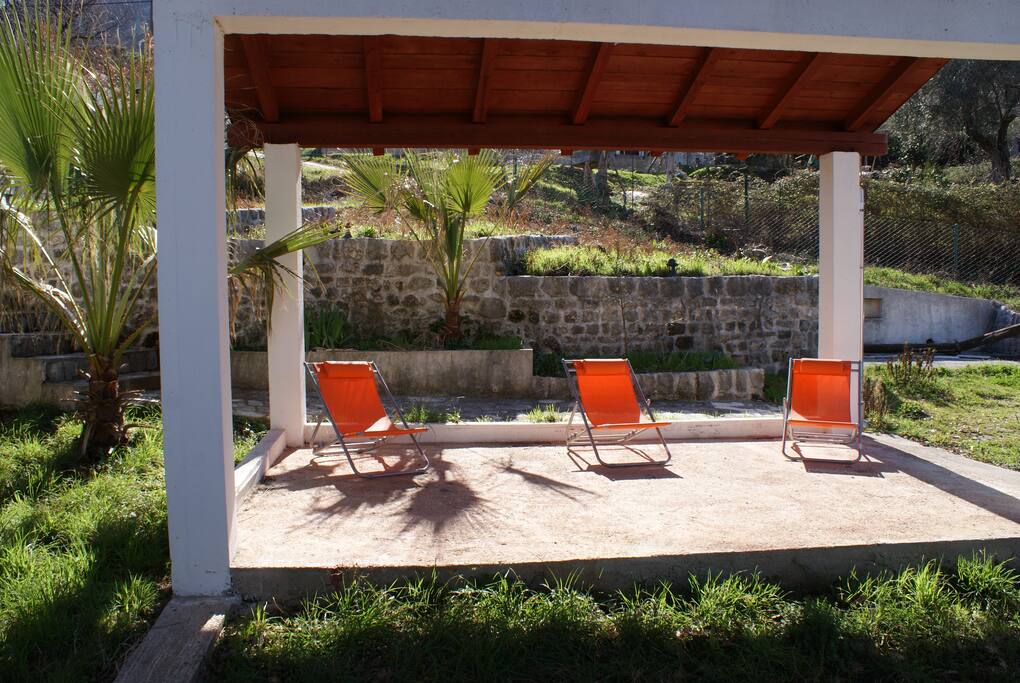 Lower summer terrace with sun loungers.