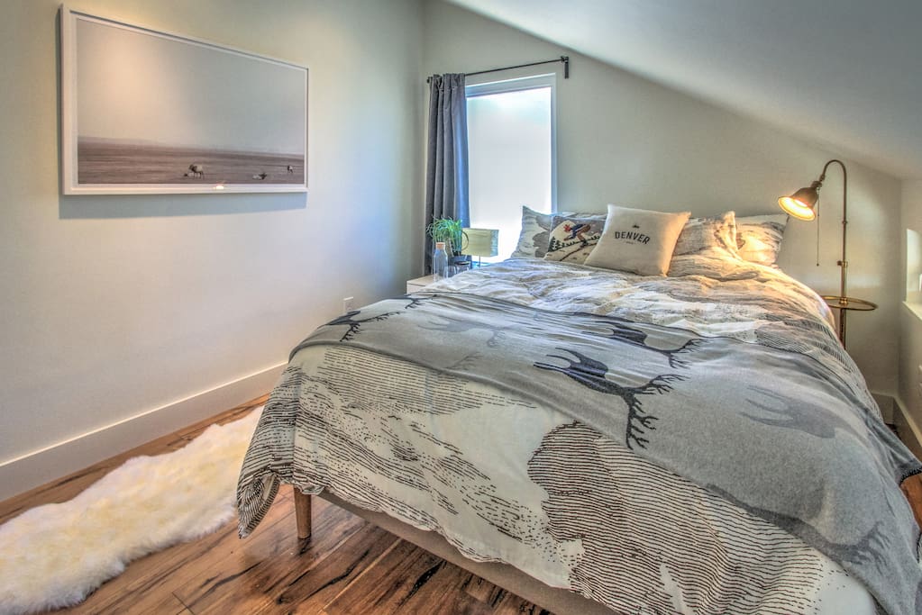 Sleep soundly in the bedroom that features a queen-sized bed with down comforter, pillows and sheepskin rug.