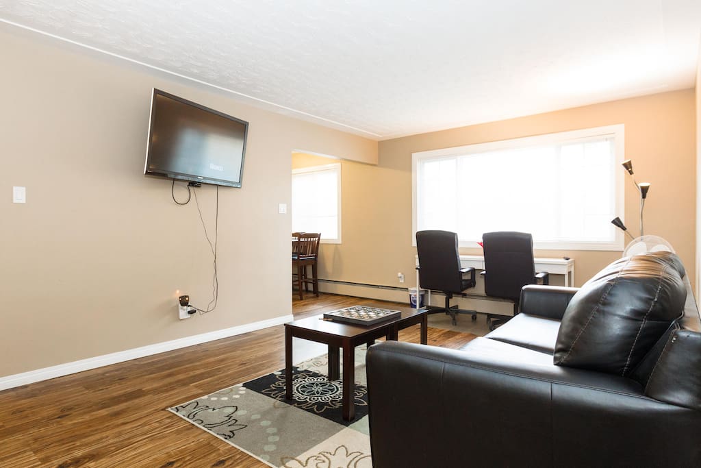 Large living room with sofa bed + Executive office chairs and desk + Free Unlimited High Speed Wifi for streaming free Netflix movies on 50" flat TV with Roku 3.