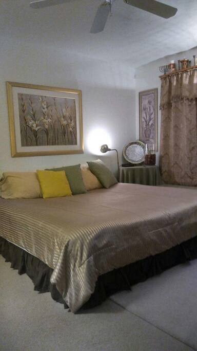 Bedroom has a King Size bed with pillows, sheets, comforters, etc