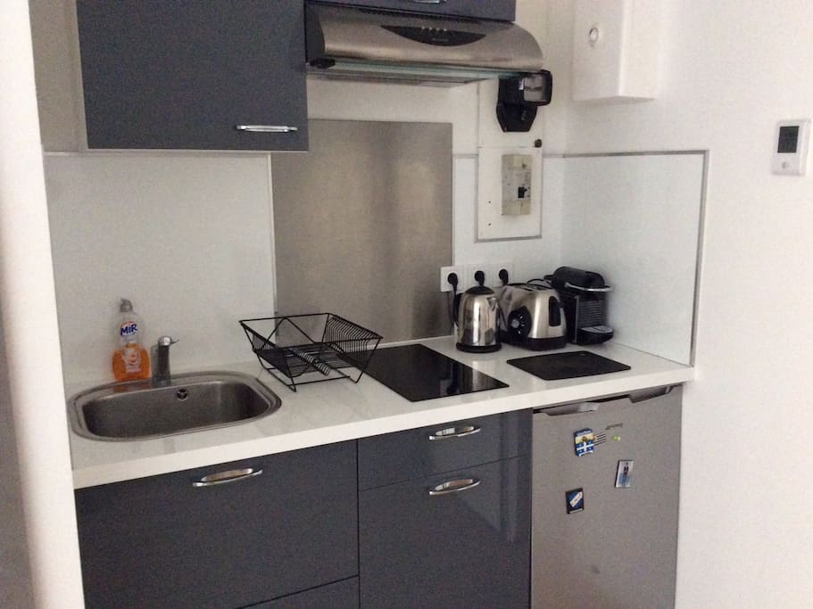 Kitchen with cooking table , toaster , water boiler and coffee machine