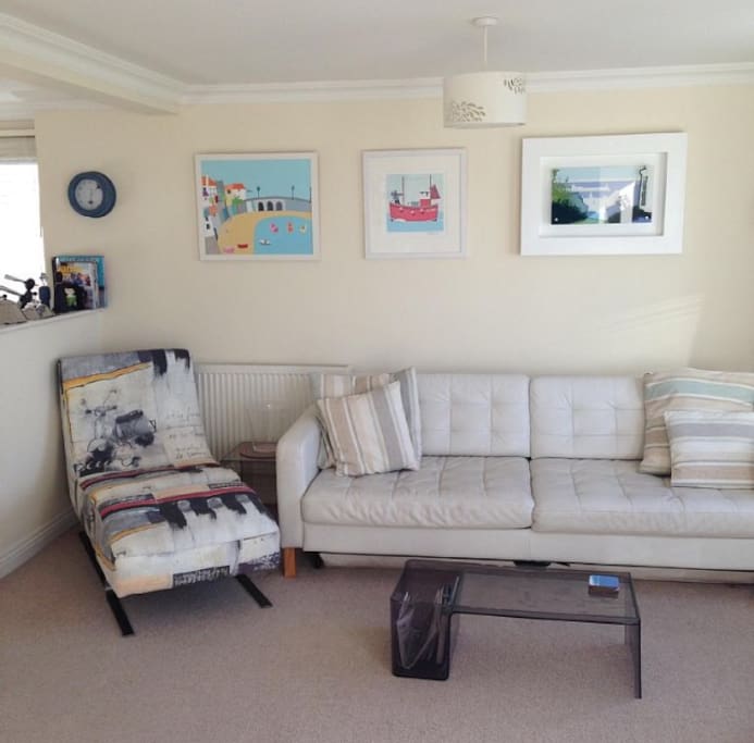Art work by Caroline Dodd, Seb West and other local artists on the Living room walls.