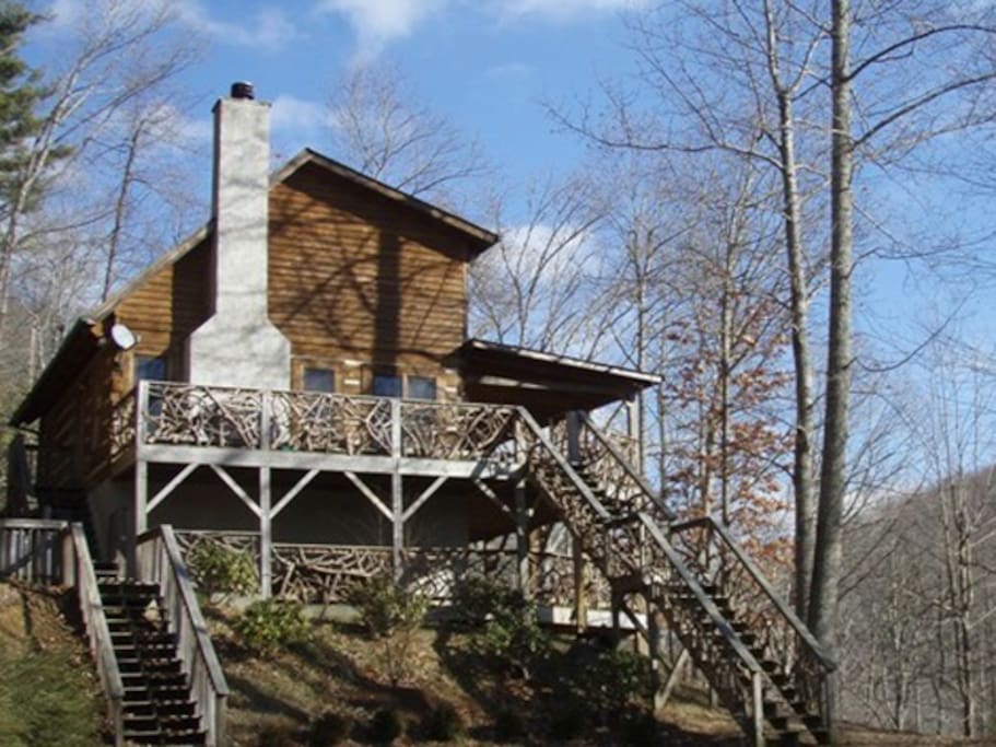 Side of home. Wood burning fireplace, hammocks on covered porch.