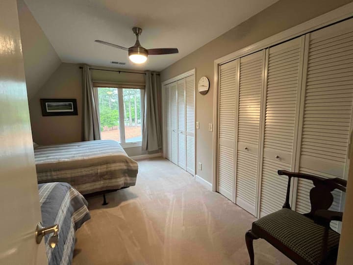 upper  level bedroom with queen and double. you can see course 3 from window