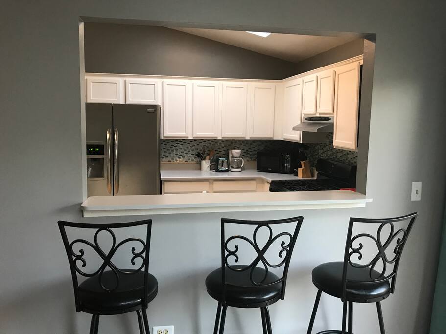 Kitchen bar seats three.