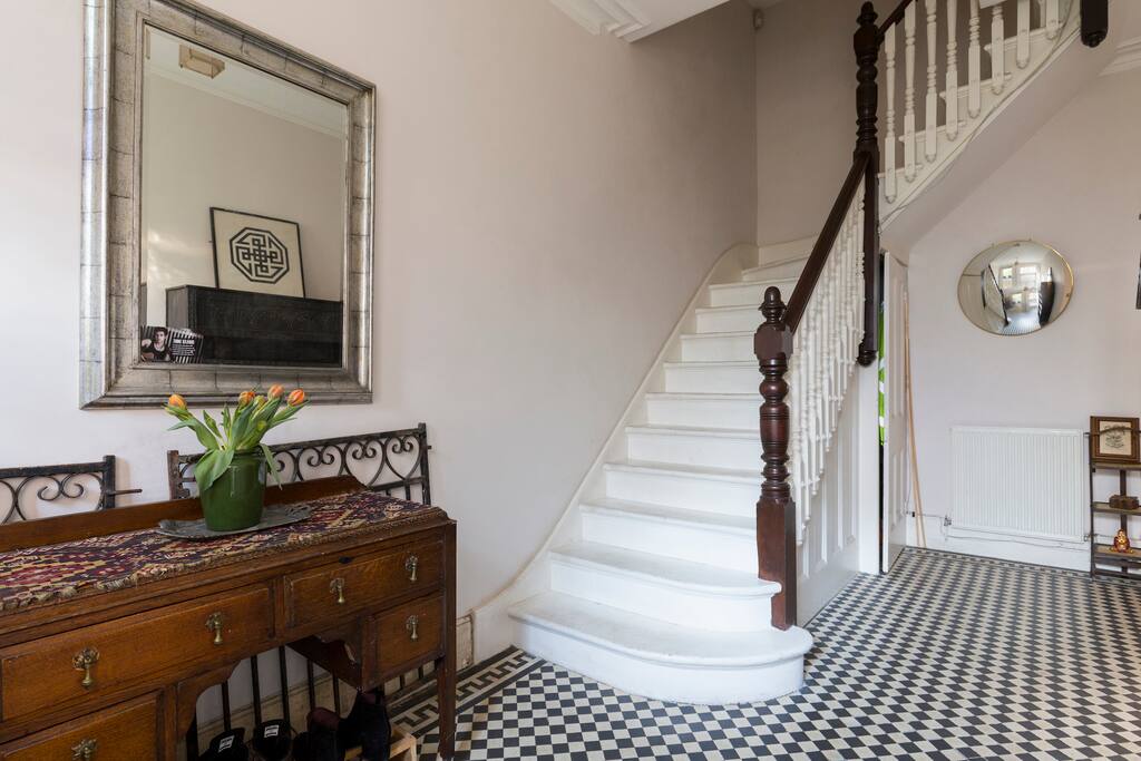 Welcoming hallway upstairs to the apartment.