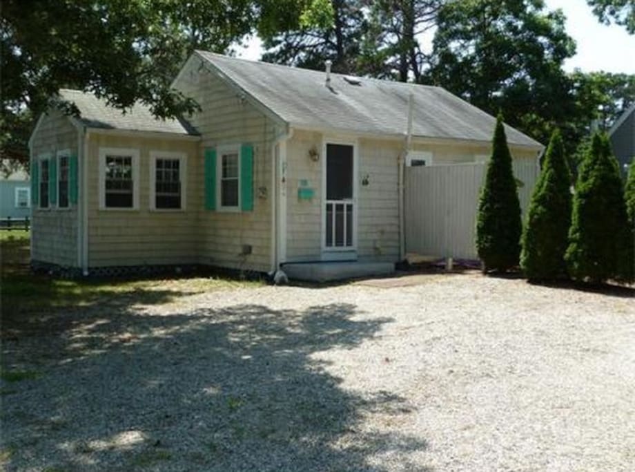 Back view with an outdoor shower and 3 season room.