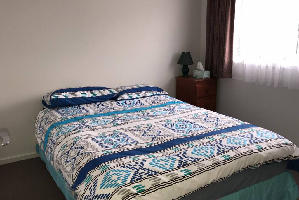 Cosy Queen double bed with cupboard space (not shown) with bathroom and toilet facilities next door