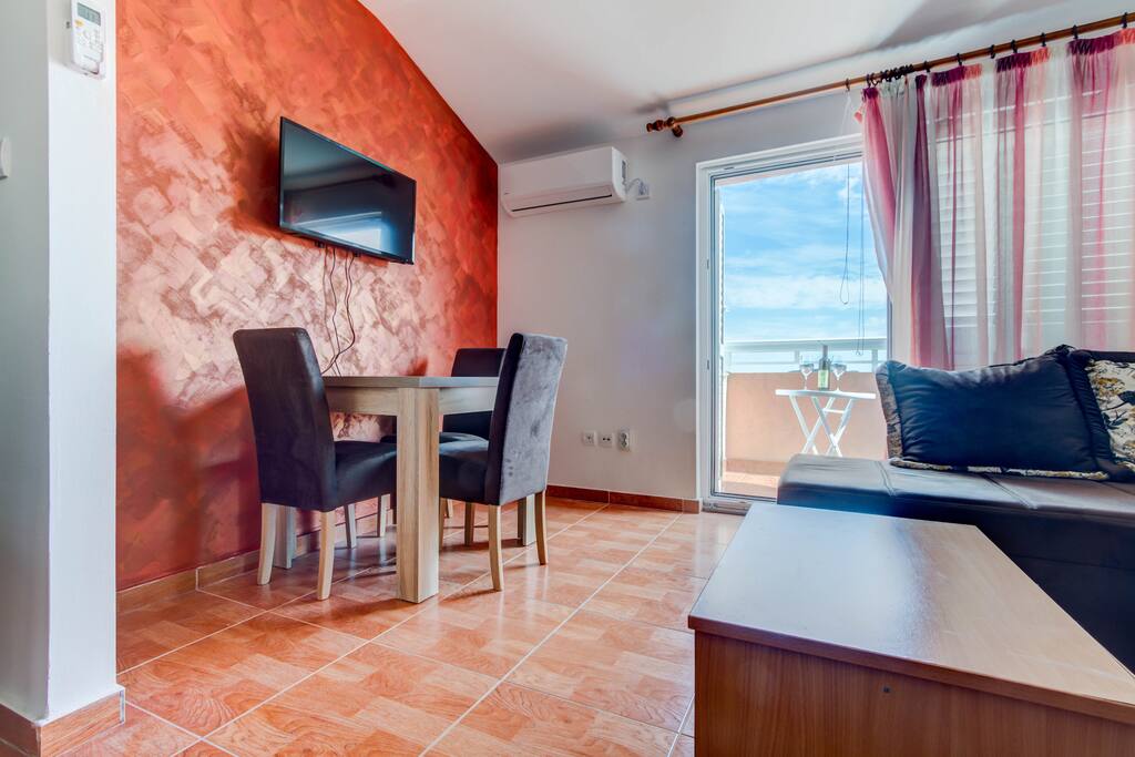 Air condition and TV are situated in living and dining area.
