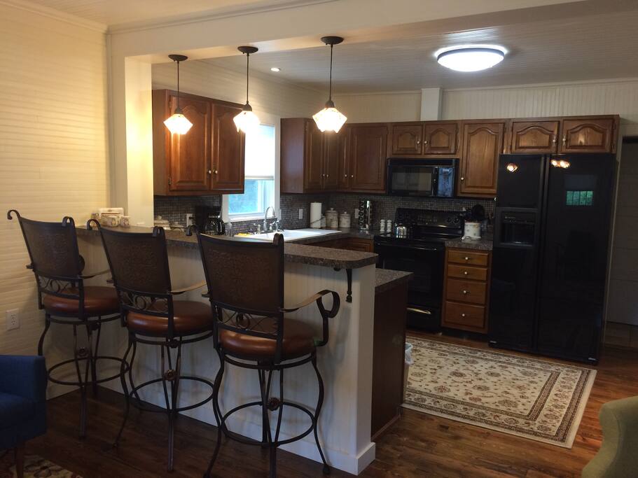 Living room across Breakfast Bar into Kitchen