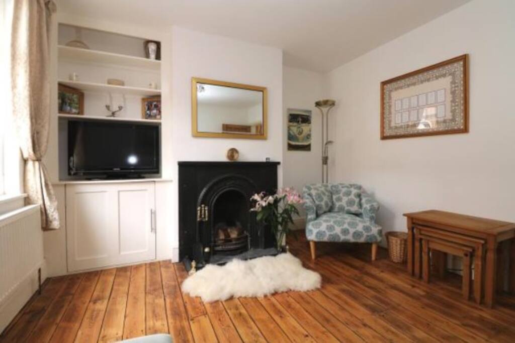 Cozy sitting room with working fireplace and Sky TV