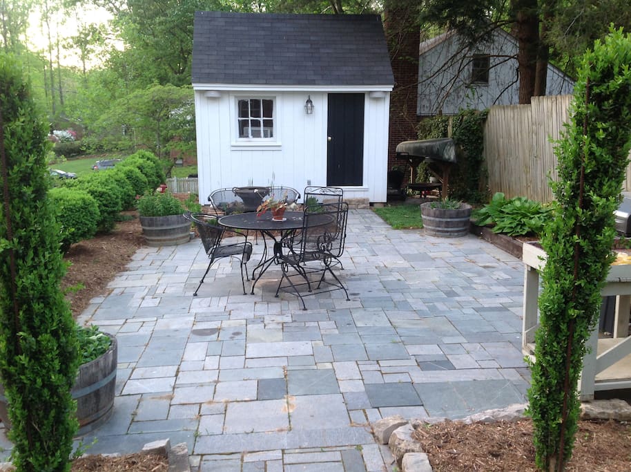 Soapstone Patio with mature boxwoods, fountain and grill.