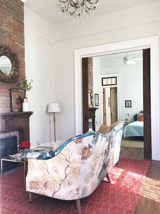 Classy and lovely living room that has 14 foot ceilings and pocket doors to the first bedroom