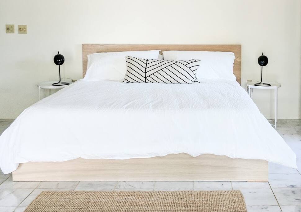 Large spacious bedroom with King size bed and high ceilings.