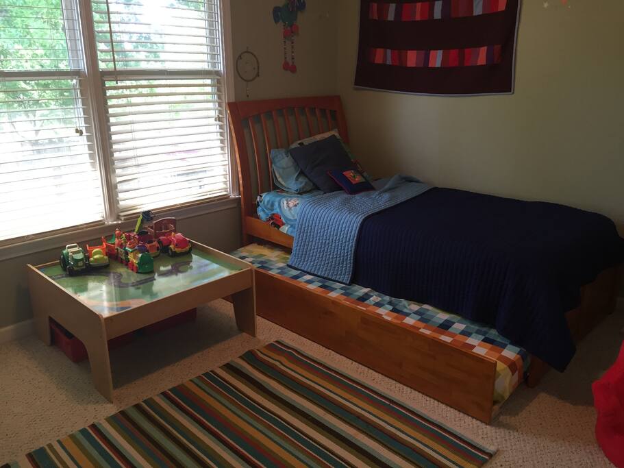 This is our son's room - his bed is a very comfortable twin that a grownup can sleep and a trundle bed (pictured here under the bed). We are happy to remove the train table if guests prefer.