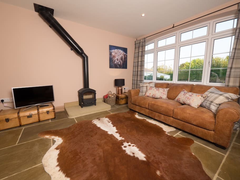 Comfortable seating area with leather seats and a cow hide rug.